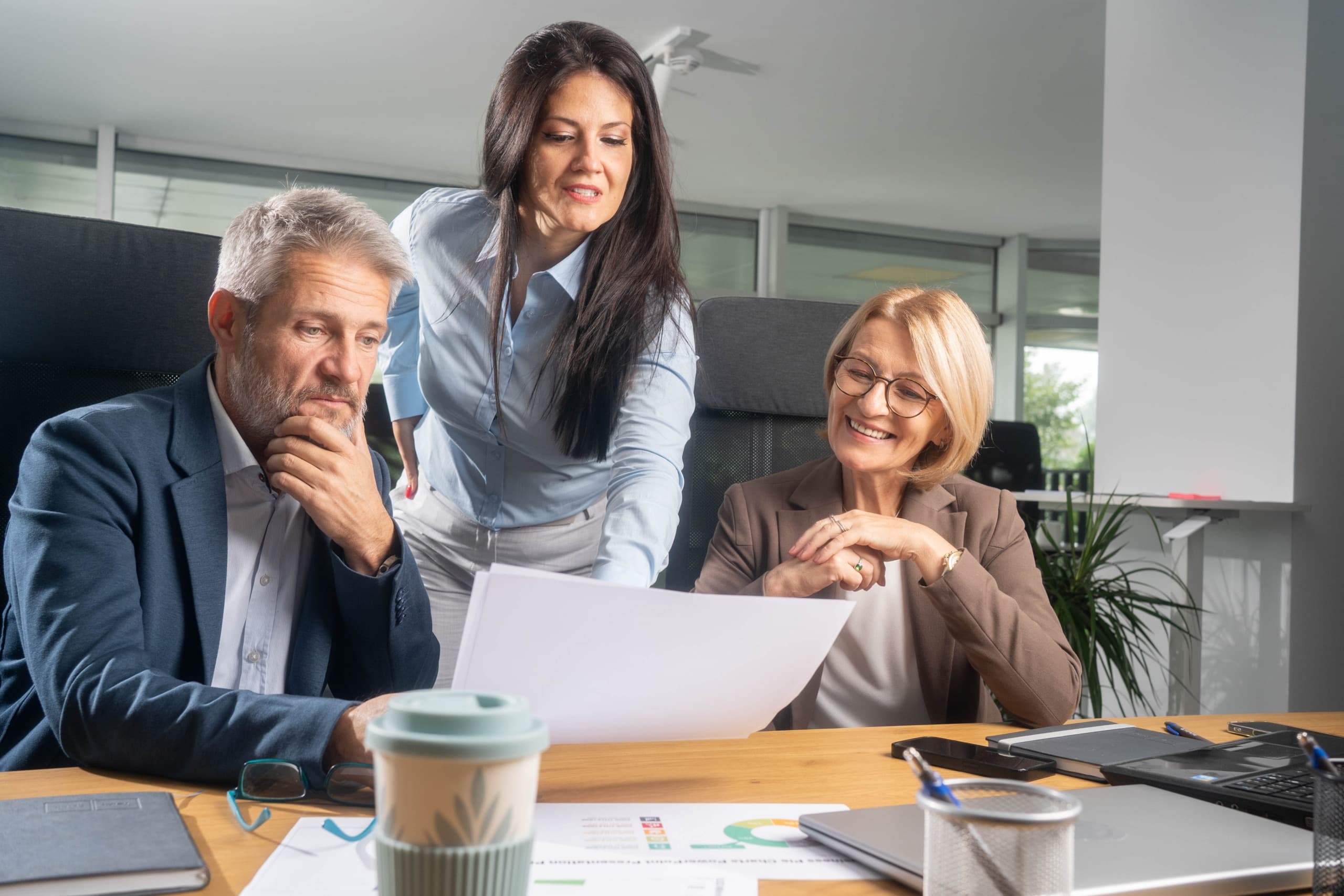 Insurance broking team reviewing documents together in an office meeting