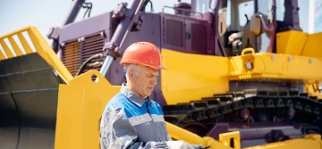 earthmoving plant and machinery operator wearing orange cap