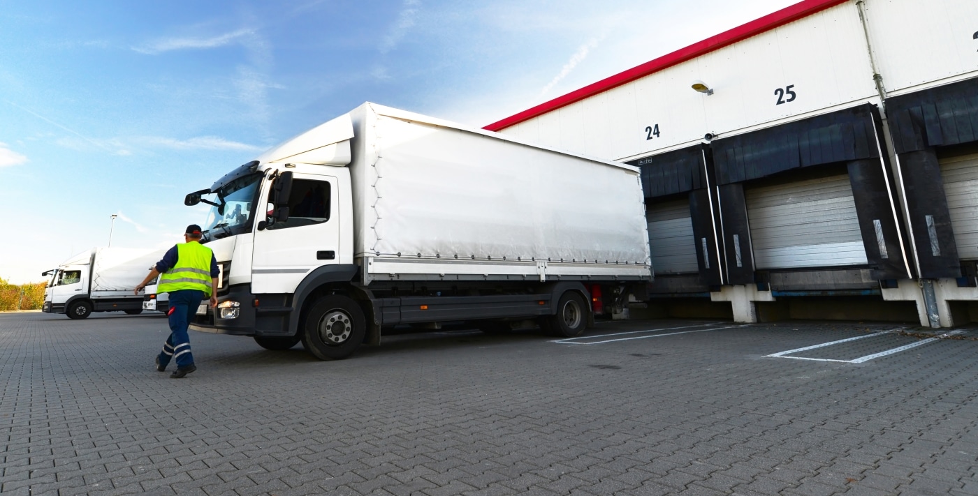 Cargo truck getting unloaded at warehouse